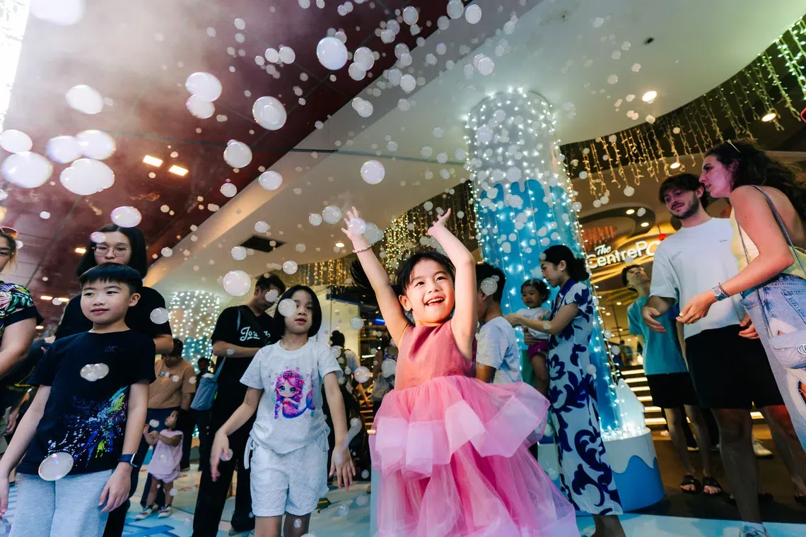Children enjoying bubbles at an indoor family event
